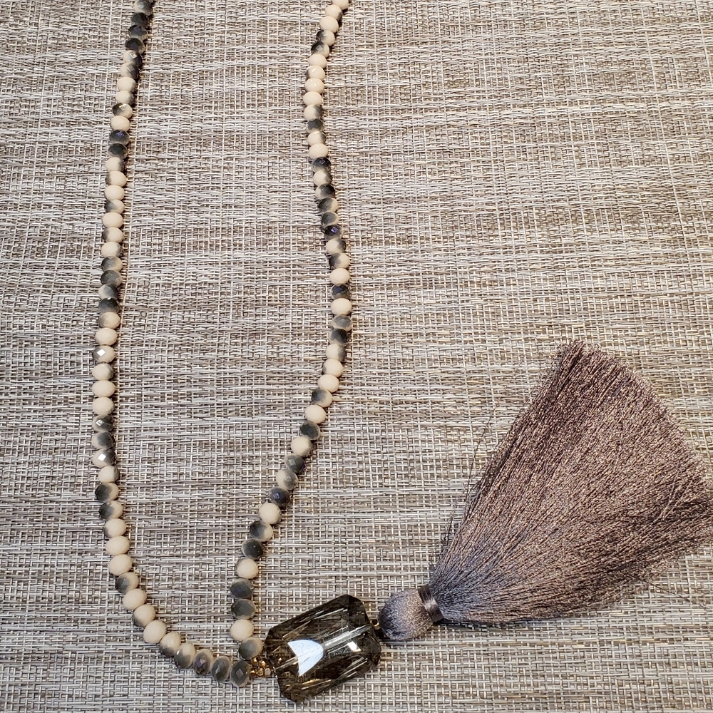 Long beaded necklace with stone and tassel drop